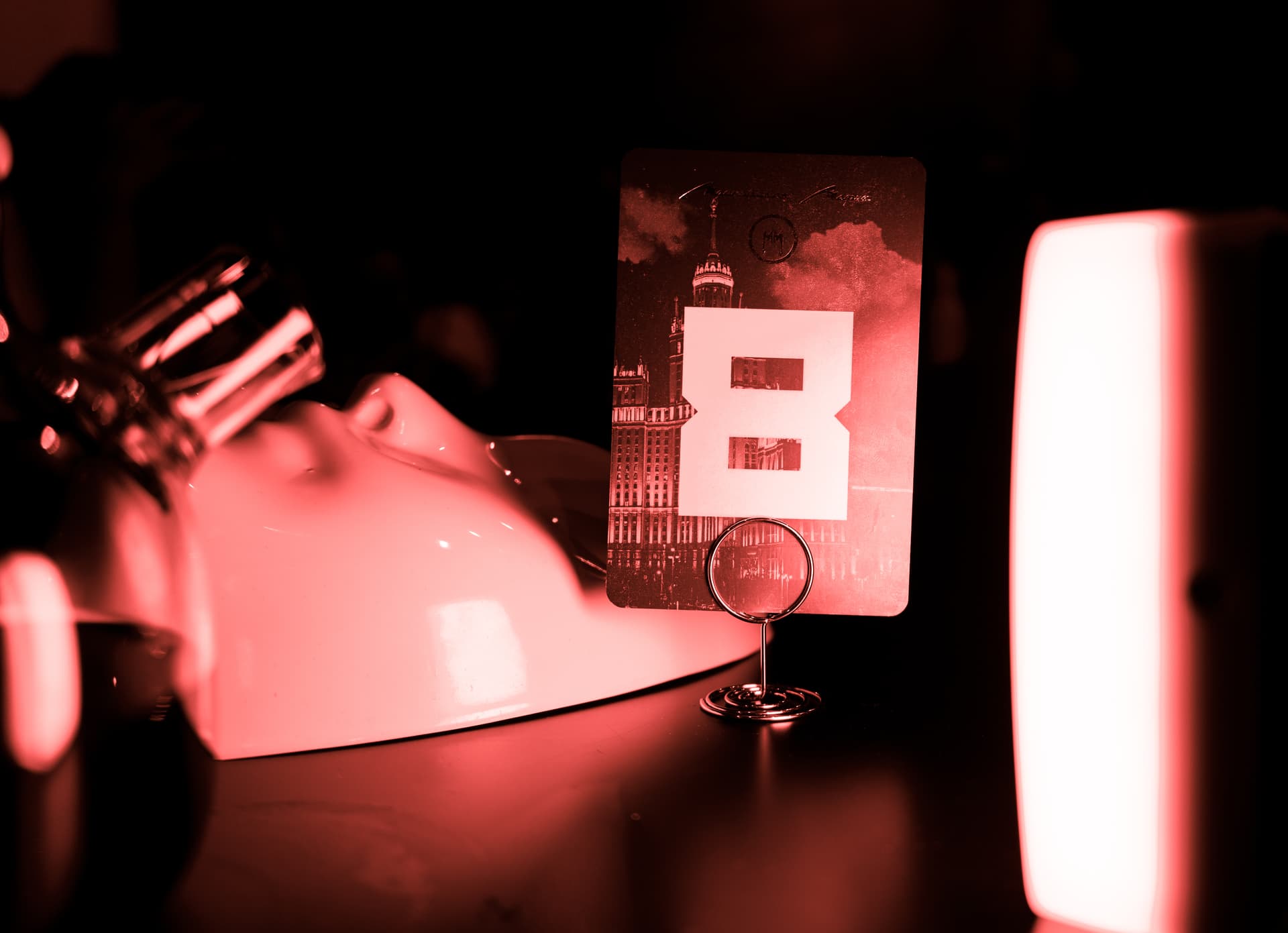 dark atmospheric shot of a smoking gun on a poker table